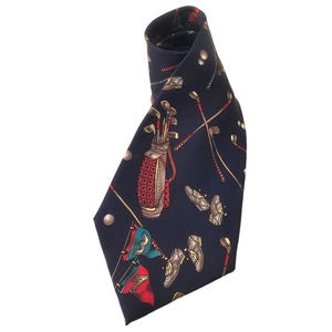 May include: A navy blue silk tie with a golf-themed print. The print features golf clubs, golf balls, golf shoes, and a golf bag.