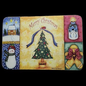 May include: A colorful Christmas-themed placemat with a green Christmas tree, a snowman, a gingerbread man, and a candle. The placemat has the words "Merry Christmas" written on it.