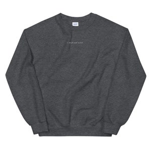 May include: A dark gray sweatshirt with the text "I shall not want" printed in white on the front.