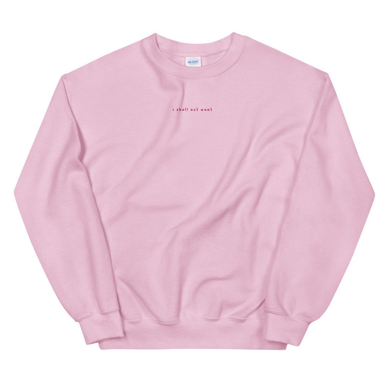 May include: A pink crewneck sweatshirt with the text "I shall not want" embroidered in red on the front.
