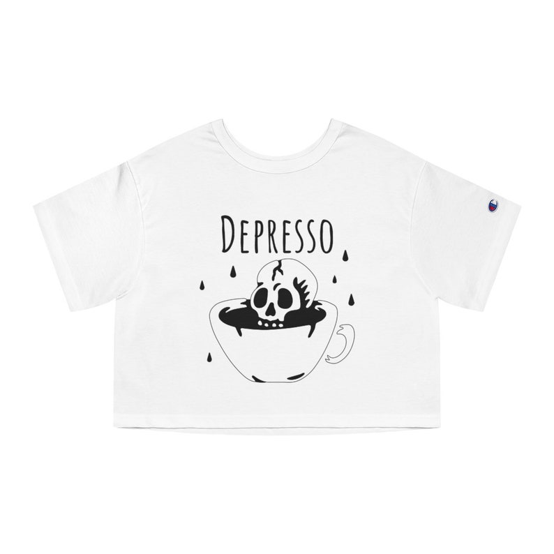 May include: White cropped t-shirt with a black and white illustration of a skull in a coffee cup. The text "DEPRESSO" is above the illustration.