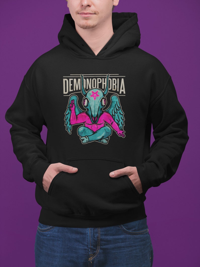 May include: Black hooded sweatshirt with a pink and blue demon graphic and the text "DEMONOPHOBIA" in white.