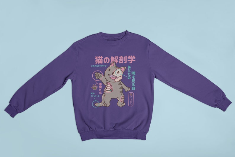 May include: Purple sweatshirt featuring a cartoon cat anatomy illustration. The text on the shirt reads "猫の解剖学" and "あなたの猫を見る目".