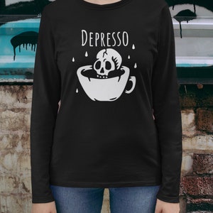 May include: Black long-sleeve shirt with a white graphic of a skull in a coffee cup with the text "DEPRESSO" above it.