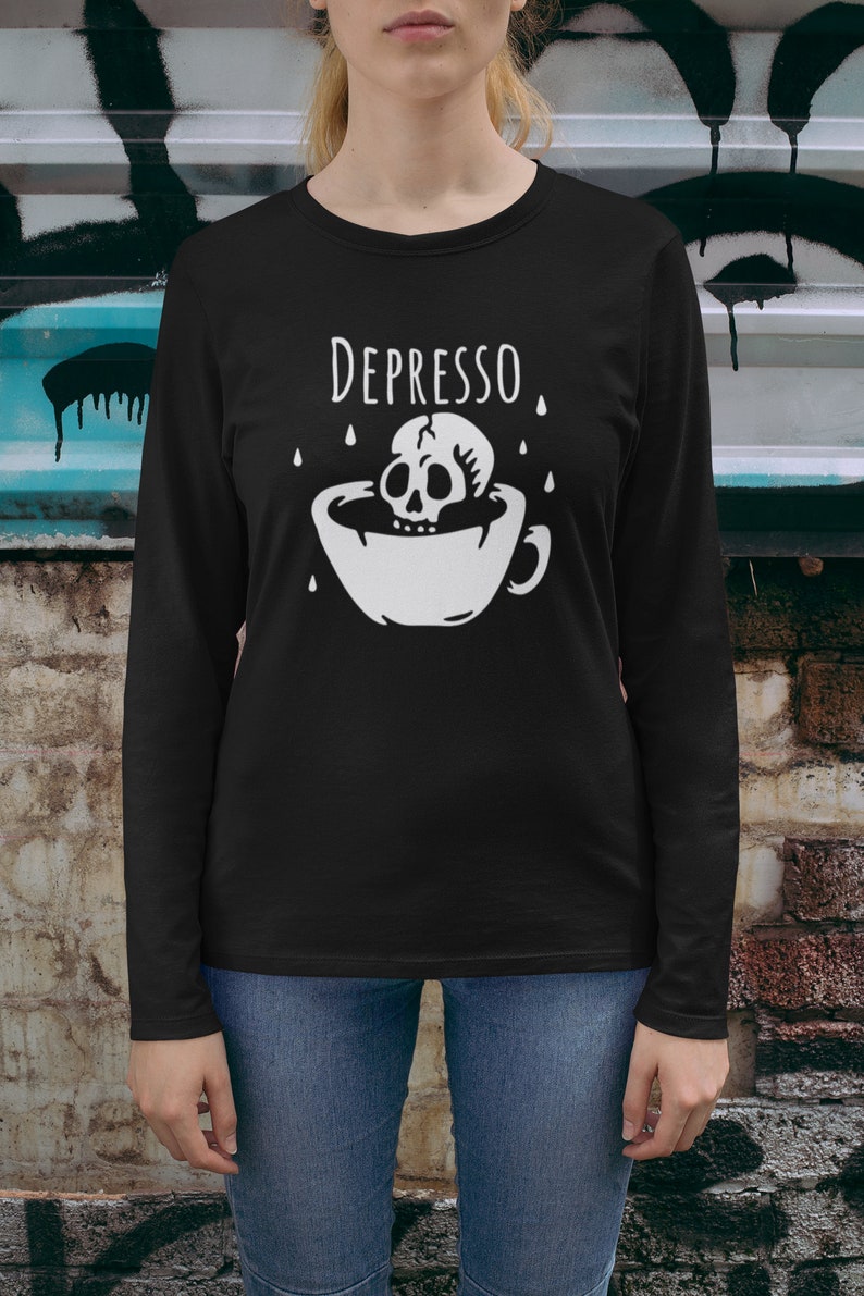 May include: Black long-sleeve shirt with a white graphic of a skull in a coffee cup with the text "DEPRESSO" above it.