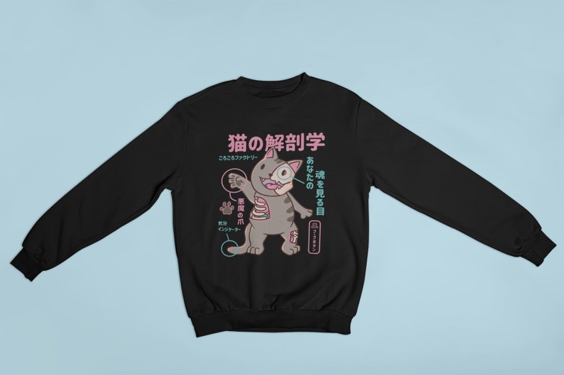 May include: Black sweatshirt featuring a graphic of a cat with anatomical details labelled in Japanese. The text reads "Cat Anatomy" and "See your soul".