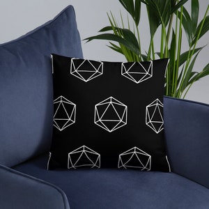 May include: Black and white throw pillow with a geometric pattern of white icosahedrons on a black background.