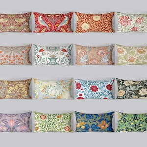 May include: A collection of rectangular throw pillows with various floral and botanical patterns. The pillows feature a range of colors, including red, green, blue, and brown, with detailed designs of flowers, leaves, and birds.