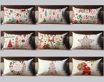 May include: Nine decorative Christmas-themed throw pillows with various festive designs. Pillows feature patterns of reindeer, Christmas trees, Santa Claus, and the words "Merry Christmas" in red, green, and pink on a white background.
