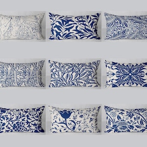 May include: Nine decorative throw pillows with a white background and blue floral patterns. The pillows are arranged in three rows of three.
