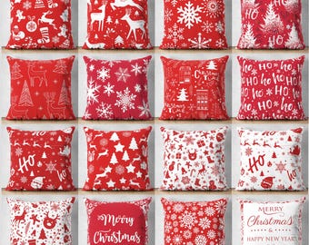 May include: A collection of sixteen square throw pillows featuring various red and white holiday patterns, including reindeer, snowflakes, Christmas trees, Santa Claus, gingerbread men, and text such as 'HO', 'Christmas Time', and 'Merry Christmas'.
