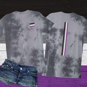 May include: Two grey tie-dye t-shirts with an asexual pride flag design. One shirt has a small square flag on the front, the other has a vertical flag on the back.