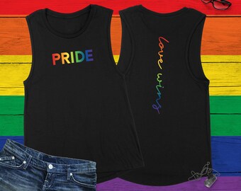 Puede incluir: Camiseta de tirantes negra con letras arcoíris que dicen "PRIDE" en la parte delantera y "love wins" en la parte trasera.
