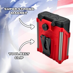 May include: A red and black tool holder with a tool belt clip and a super strong magnet. The holder has gray accents and the text "EUREKA 3D PRINTING LLC". The background features a red, white, and blue American flag design.