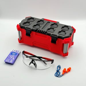 May include: A red and black toolbox with a black top, safety glasses, earplugs, and a lens cleaning wipe. The safety glasses have a black frame with red accents. The earplugs are orange and blue. The lens wipe has the text "LENS" and "nice n' clean".