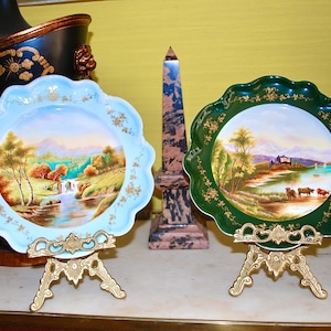 Hand painted and signed pair of bone china cabinet plates made by Coalport in the 20th century