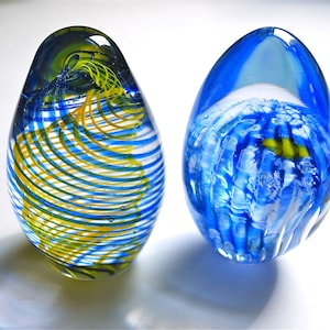 Two large glass vintage paperweights with spiral and marine design in excellent condition