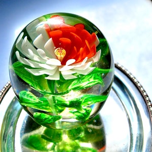 Large vintage paperweight with extraordinarily alive orchid inside and natural green foliage