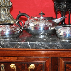 Antique early 20th century silver plated large teapot, sugar bowl and milk jar, hand embossed with delicate ivy garlands