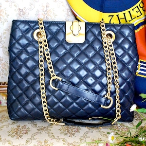 Designer handbag by Jaeger London I n a classical quilted quality leather in navy blue with gold accessories