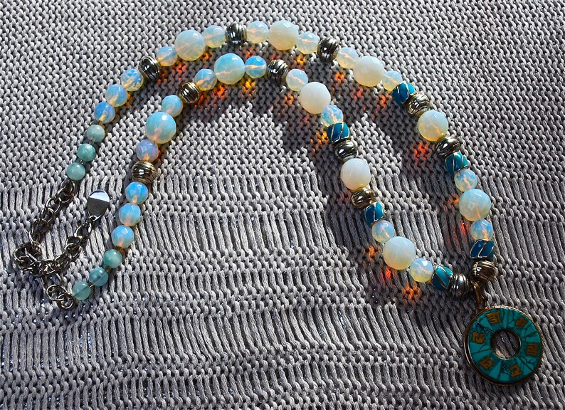 Gemstone necklace from faceted opalite beads and metal and blue enamel with beautiful Tibetan prayer medallion