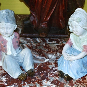 Large pair of antique fine porcelain figurines by Gebruder Heubach of Lichte Germany of a boy and a girl in exquisite costumes