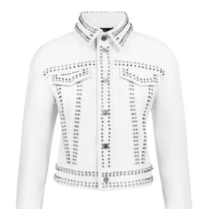 May include: White jacket adorned with silver studs and rhinestones. It has a collared neckline, two chest pockets, and a button-up front. The cuffs and collar are heavily embellished.