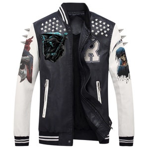 May include: Black and white varsity jacket with graphic art on the sleeves and chest. The jacket features a black body, white sleeves, and silver stud accents. The jacket has a zipper closure and a ribbed collar and cuffs.