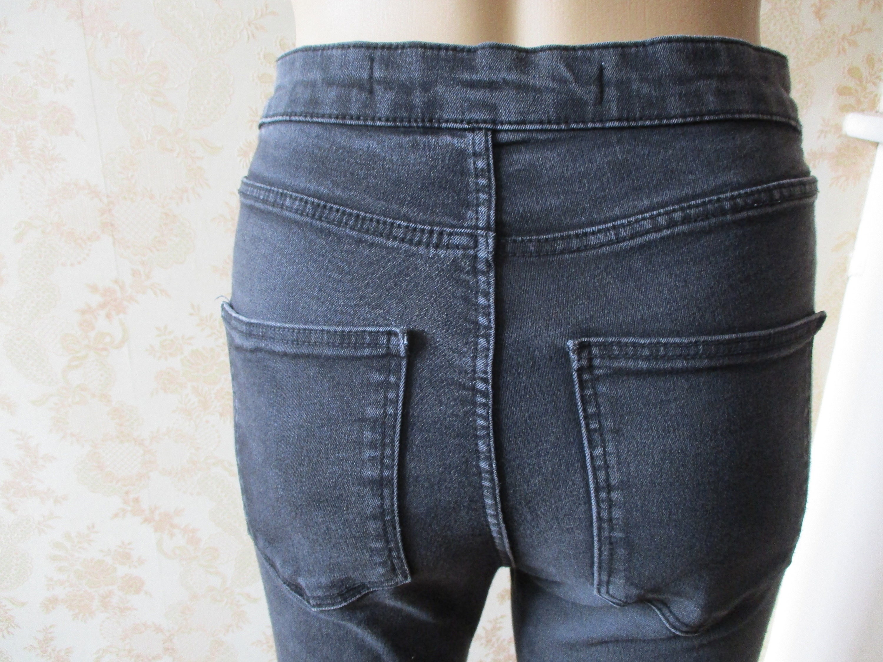 Black Stretch Jeans With a Red and White Stripe on Legs