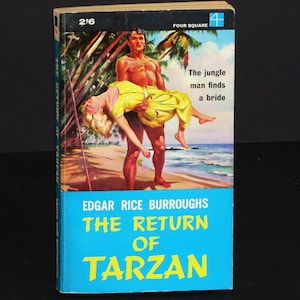 May include: Vintage paperback book cover for "The Return of Tarzan" by Edgar Rice Burroughs. The cover art depicts a muscular man carrying a woman in a yellow dress on a beach. Text includes the title and author's name.