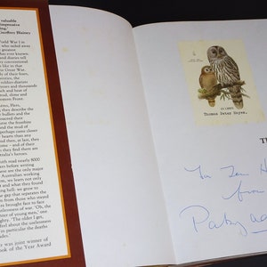 May include: A signed copy of the book "The Anzacs" by Patsy Adam-Smith. The book cover features a brown background with gold lettering. The inscription reads "To Jan Hayes from Patsy Adam-Smith".