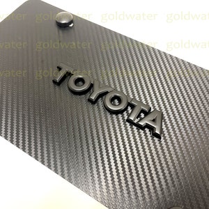 3D Black Toyota Emblem Badge Carbon Fiber Style Aluminum Vanity Front License Plate Black Trim