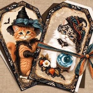 May include: Two coffin-shaped decorative tags featuring illustrations of cats. One tag shows an orange tabby cat in a witch hat and cape. The other shows a white cat with a lace veil and a crystal ball. Both tags have ornate black lace borders.