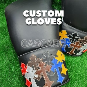 May include: Black leather gloves with colorful cross designs on the cuffs. The text "CUSTOM GLOVES" and "CASCADE" are visible on the gloves. The crosses are in red, yellow, blue, brown, and gray.