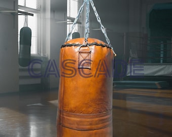 Saco de boxeo de piel de vaca artesanal: resistente, decoración retro para gimnasios.