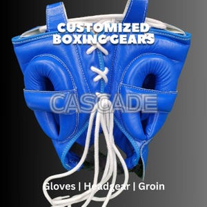 May include: Blue boxing headgear with white laces and a white CASCADE logo. The headgear has ear and cheek protection.  CUSTOMIZED BOXING GEARS is written at the top. Gloves | Headgear | Groin is written at the bottom.