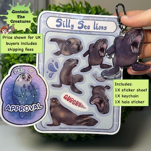 May include: A sticker sheet, keychain, and holo sticker set featuring cartoon sea lions. The sticker sheet has multiple sea lion illustrations. The keychain is a clear acrylic sea lion. The stickers and keychain are in shades of brown and blue.