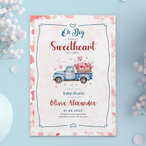 May include: A baby shower invitation with a pink and white background. The invitation features a blue pickup truck with red hearts and the text "Oh Boy A Little Sweetheart In Coming".