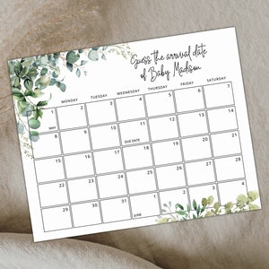 Puede incluir: Un calendario imprimible con un borde verde de hojas. El calendario es para mayo y junio y tiene el texto "Adivina la fecha de llegada de Baby Mackson" en la parte superior.