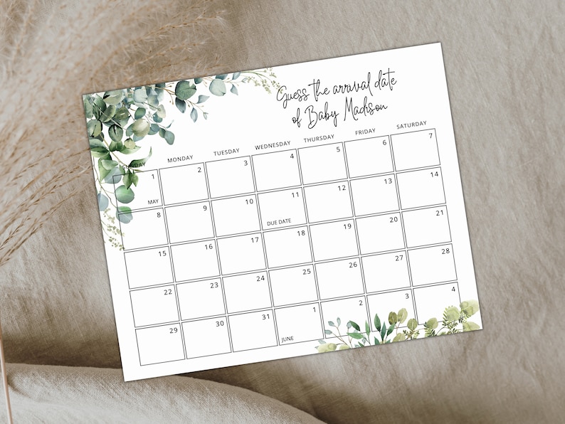Puede incluir: Un calendario imprimible con un borde verde de hojas. El calendario es para mayo y junio y tiene el texto "Adivina la fecha de llegada de Baby Mackson" en la parte superior.