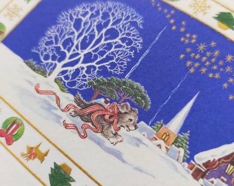 May include: A Christmas card featuring a snowy winter scene with a small dog wearing a red bow, a church steeple, and a house with a lit window. The card has a blue background with gold stars and a gold border with green trees and red bows.