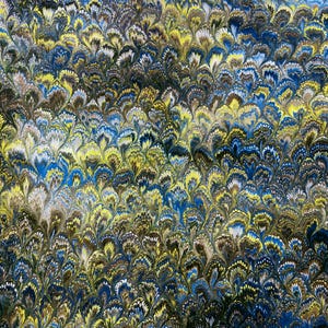 May include: A sheet of paper featuring a marbled pattern with a repeating fan-like design. The surface displays a dense arrangement of overlapping shapes in shades of deep blue, bright yellow, white, and dark brown, creating a textured visual effect.