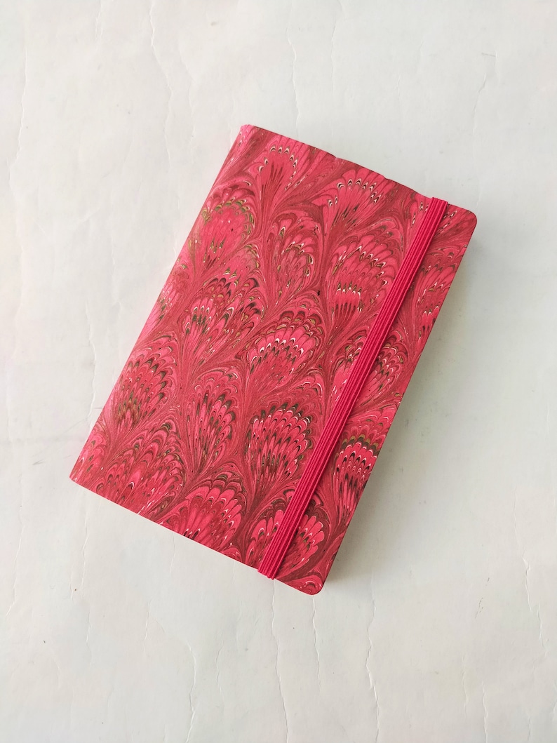 Red 100% recycled soft cover journal, hand marbled withbookmark and elastic band