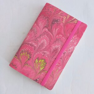 Pink 100% recycled soft cover journal, hand marbled withbookmark and elastic band