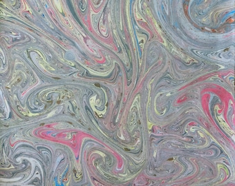 May include: Abstract marbled paper with swirling patterns in shades of grey, pink, yellow, and blue. The design features a fluid, organic aesthetic, with a mix of light and dark tones creating depth and movement. Ideal for stationery or art projects.