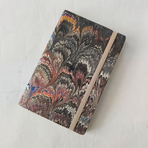 Multicolour 100% recycled soft cover journal, hand marbled withbookmark and elastic band