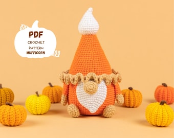 May include: A crocheted pumpkin gnome with a white beard and hat, surrounded by small crocheted pumpkins in orange and yellow. The image includes the text "PDF CROCHET PATTERN MUFFICORN".
