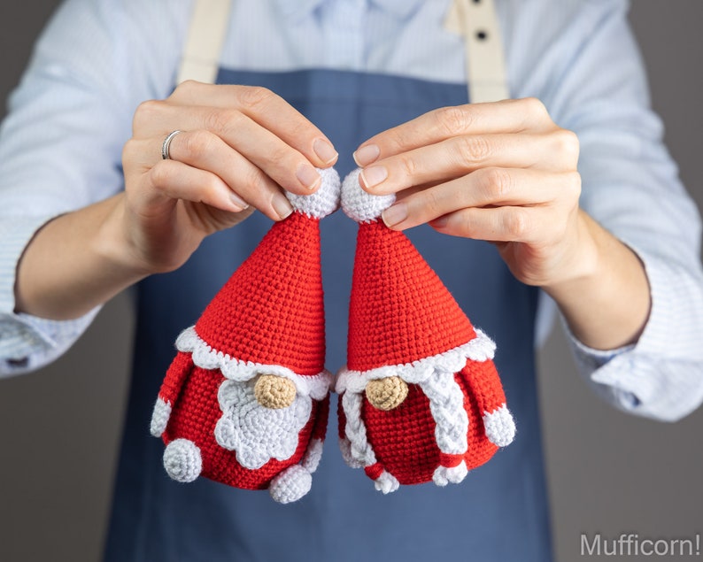May include: Two crocheted gnome ornaments in red and white. The gnomes have white beards and white hats with white pom-poms.
