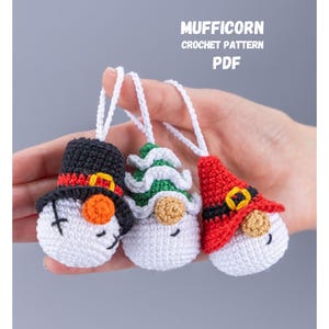 May include: Crochet pattern PDF for three Christmas ornaments: a snowman, a gnome, and a Santa Claus. The ornaments are white with colorful hats and faces.