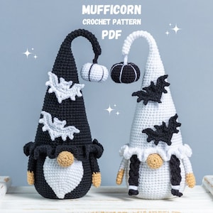 May include: Two crocheted Halloween gnomes, one black and white, the other white with black accents. Both gnomes have a pointed hat with bat appliques and a pumpkin on top. The gnomes are sitting on a white wooden surface. The text "MUFFICORN CROCHET PATTERN PDF" is at the top of the image.